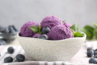 Photo of Tasty sorbet with blueberries and mint on table, closeup