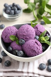 Photo of Tasty sorbet with blueberries and mint on table, closeup