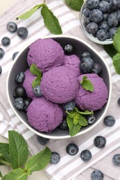 Photo of Tasty sorbet with blueberries and mint on table, flat lay