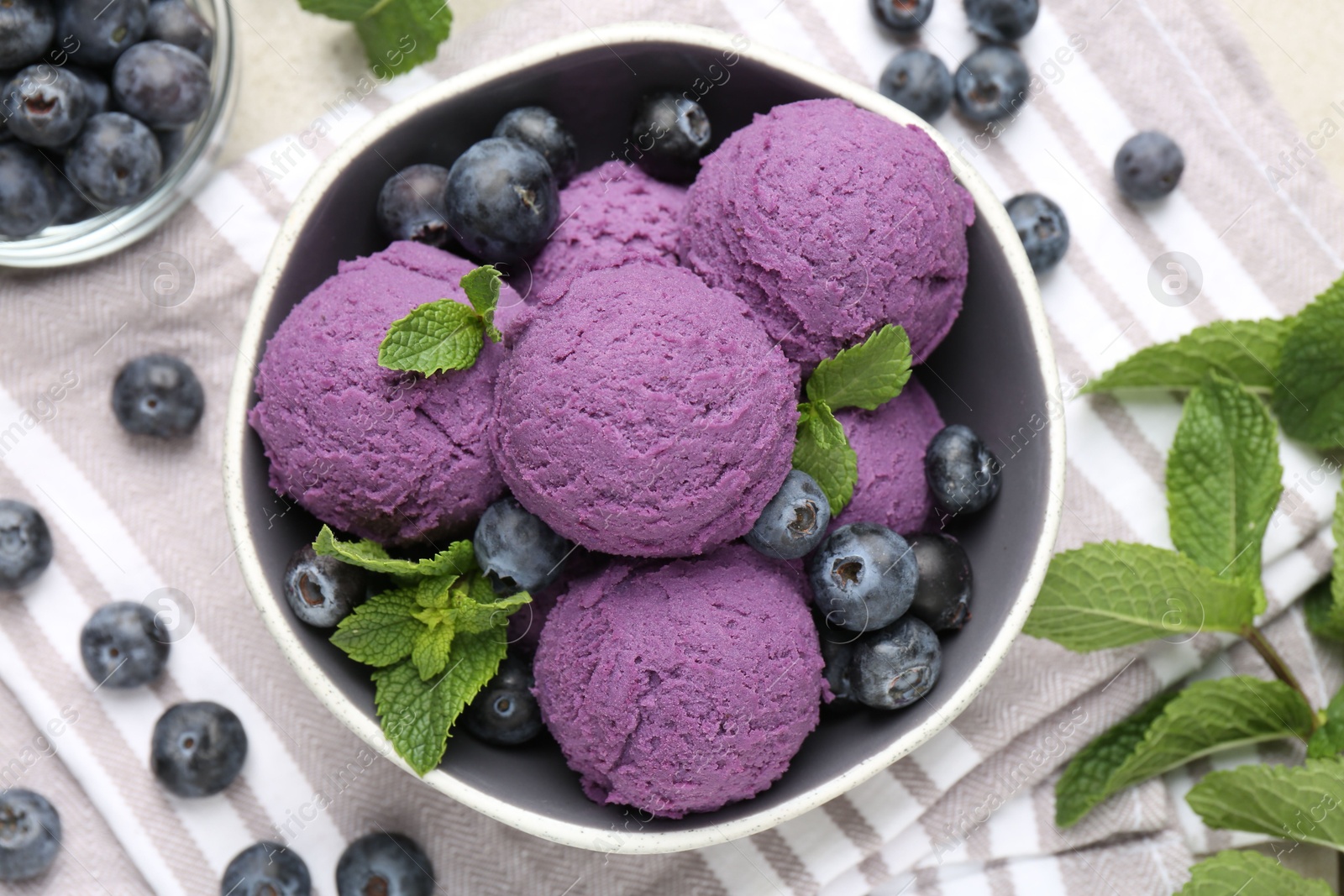 Photo of Tasty sorbet with blueberries and mint on table, flat lay