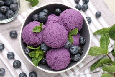 Photo of Tasty sorbet with blueberries and mint on table, flat lay