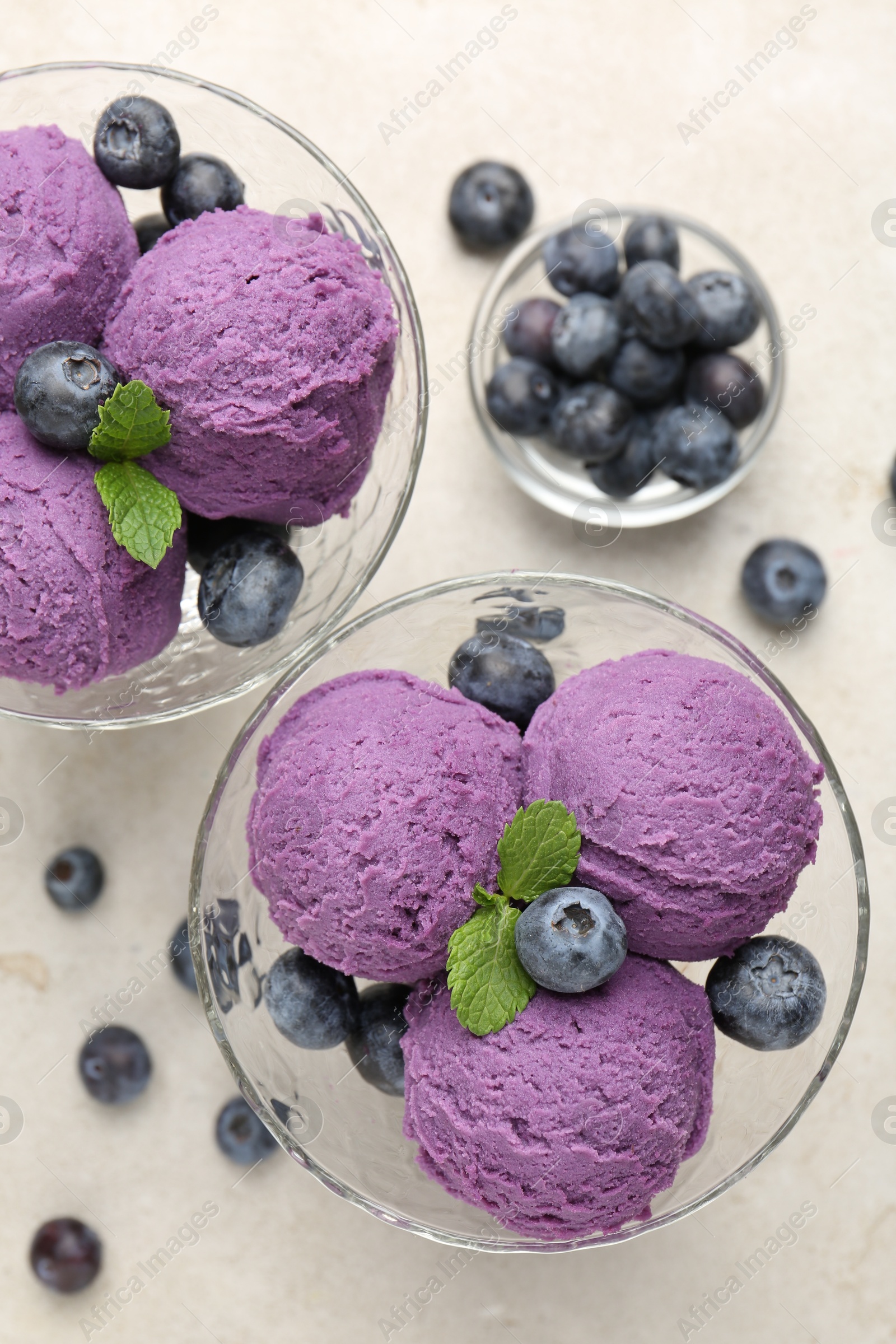 Photo of Tasty sorbet with blueberries and mint on light grey table, flat lay