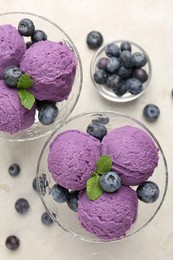 Photo of Tasty sorbet with blueberries and mint on light grey table, flat lay