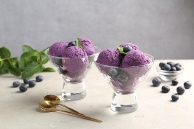 Photo of Tasty sorbet with blueberries and mint on light grey table