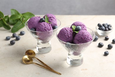 Photo of Tasty sorbet with blueberries and mint on light grey table, closeup