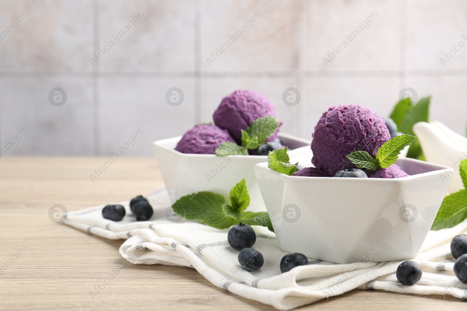 Tasty sorbet with blueberries and mint on wooden table, closeup. Space for text Photo of Tasty sorbet with blueberries and mint on wooden table, closeup. Space for text