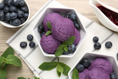 Photo of Tasty sorbet with blueberries, mint and jam on wooden table, flat lay