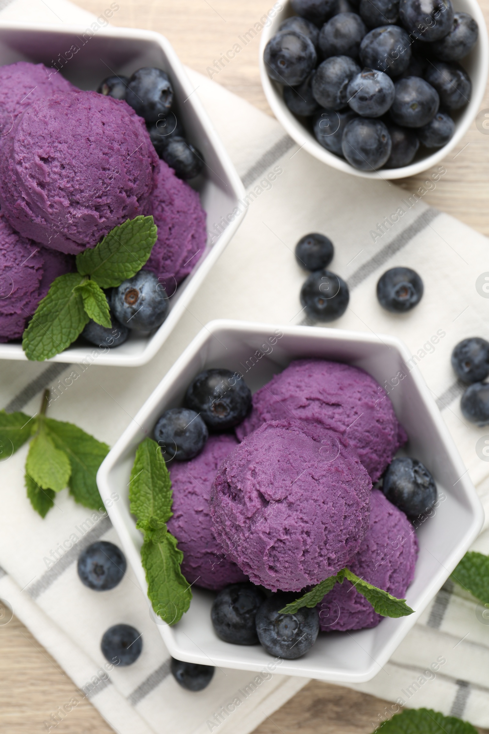 Tasty sorbet with blueberries and mint on table, flat lay Photo of Tasty sorbet with blueberries and mint on table, flat lay
