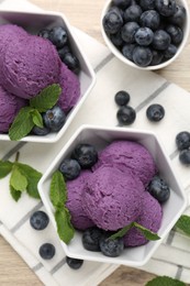 Photo of Tasty sorbet with blueberries and mint on table, flat lay