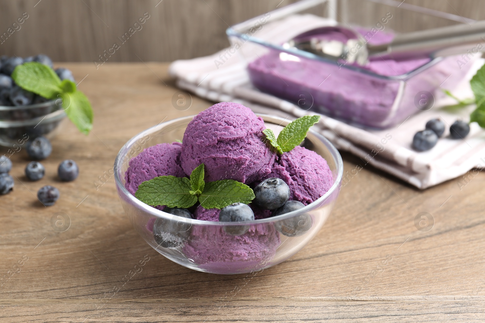 Tasty sorbet with blueberries and mint on wooden table, closeup Photo of Tasty sorbet with blueberries and mint on wooden table, closeup