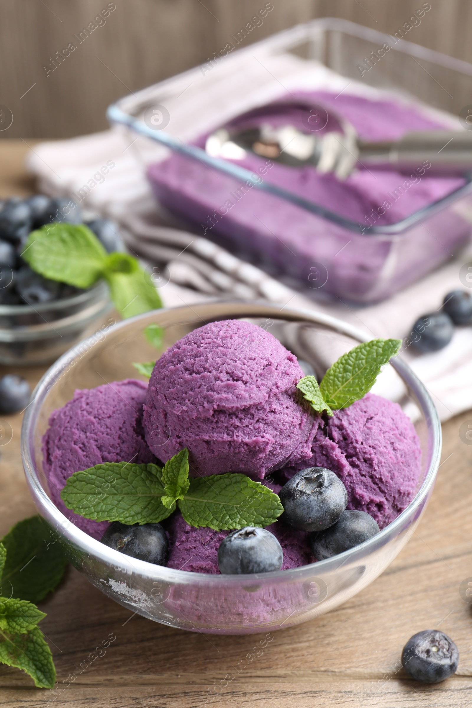 Tasty sorbet with blueberries and mint on wooden table, closeup Photo of Tasty sorbet with blueberries and mint on wooden table, closeup