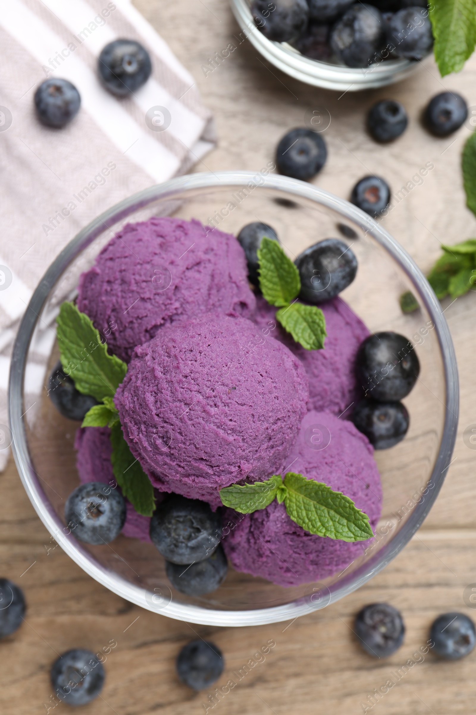 Tasty sorbet with blueberries and mint on wooden table, flat lay Photo of Tasty sorbet with blueberries and mint on wooden table, flat lay