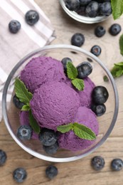 Photo of Tasty sorbet with blueberries and mint on wooden table, flat lay