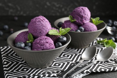 Photo of Tasty sorbet with blueberries and mint on table, closeup