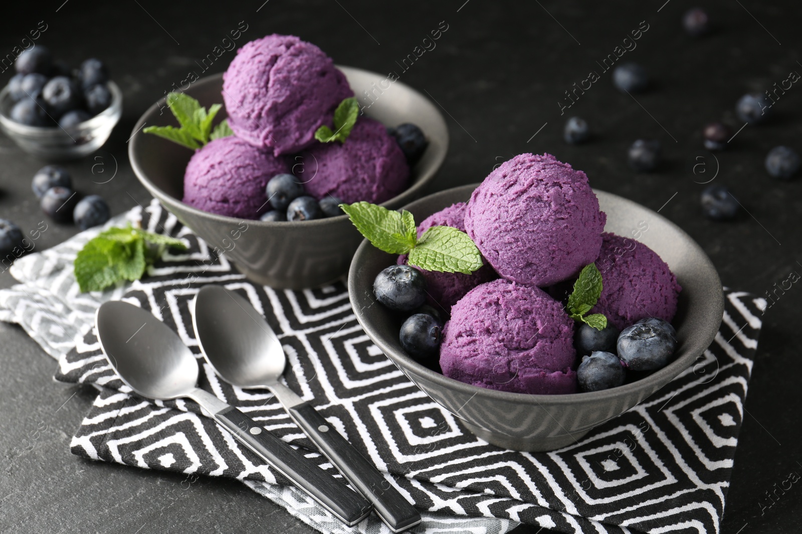 Tasty sorbet with blueberries and mint on black table, closeup Photo of Tasty sorbet with blueberries and mint on black table, closeup
