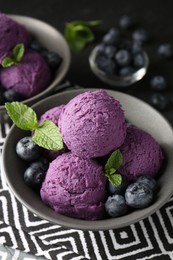 Photo of Tasty sorbet with blueberries and mint on table, closeup