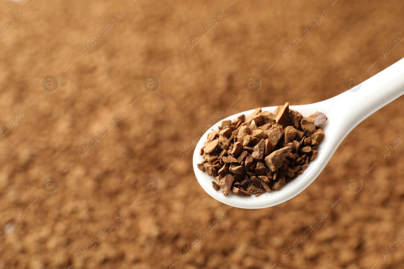 Spoon with aromatic instant coffee as background, closeup Photo of Spoon with aromatic instant coffee as background, closeup