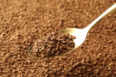 Photo of Spoon with aromatic instant coffee as background, closeup