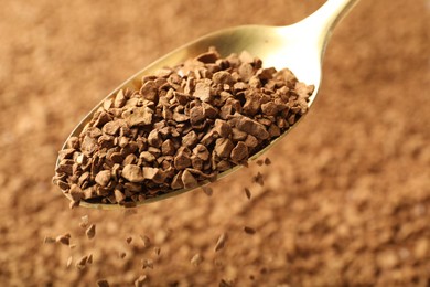 Photo of Spoon with aromatic instant coffee as background, closeup