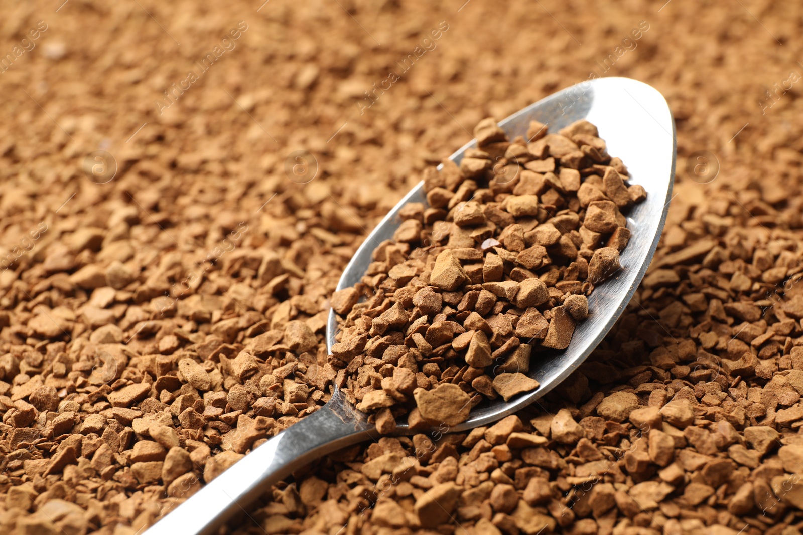 Spoon with aromatic instant coffee as background, closeup Photo of Spoon with aromatic instant coffee as background, closeup