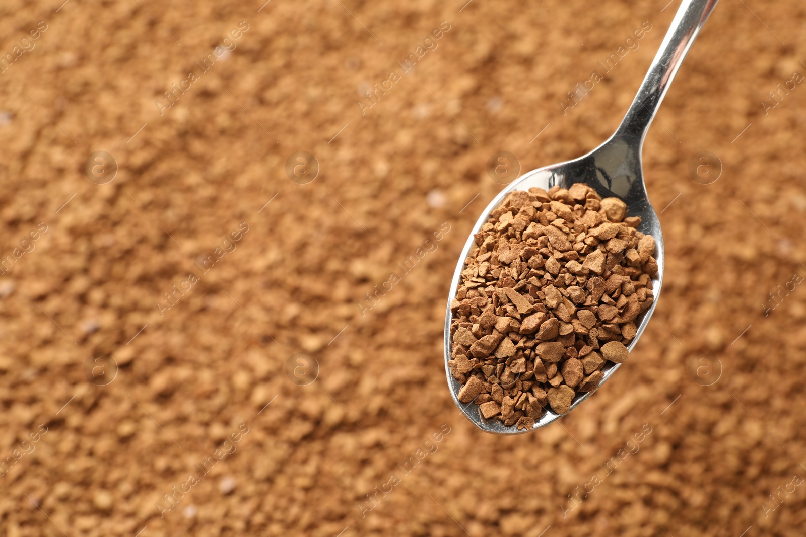 Spoon with aromatic instant coffee as background, closeup Photo of Spoon with aromatic instant coffee as background, closeup