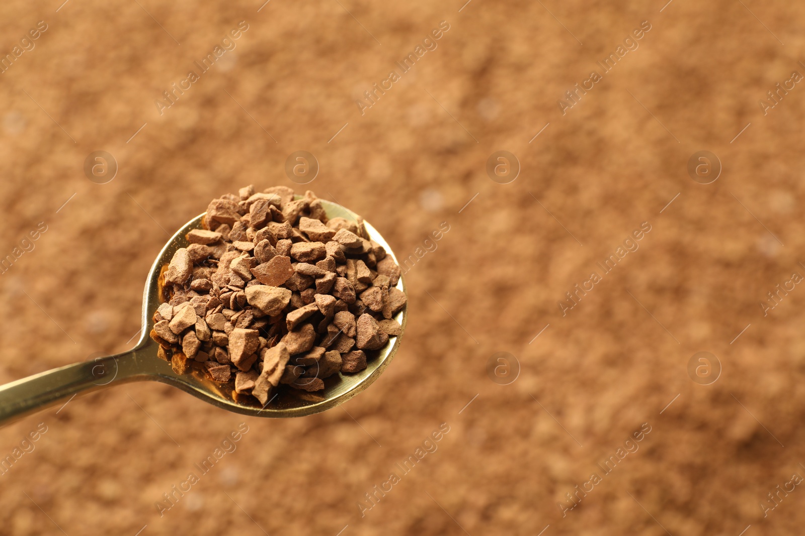 Spoon with aromatic instant coffee as background, closeup Photo of Spoon with aromatic instant coffee as background, closeup