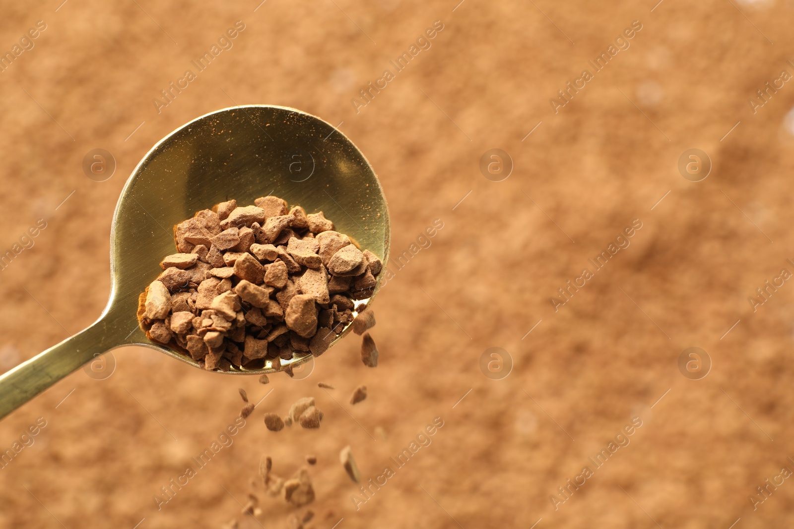 Spoon with aromatic instant coffee as background, closeup Photo of Spoon with aromatic instant coffee as background, closeup