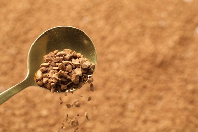 Photo of Spoon with aromatic instant coffee as background, closeup