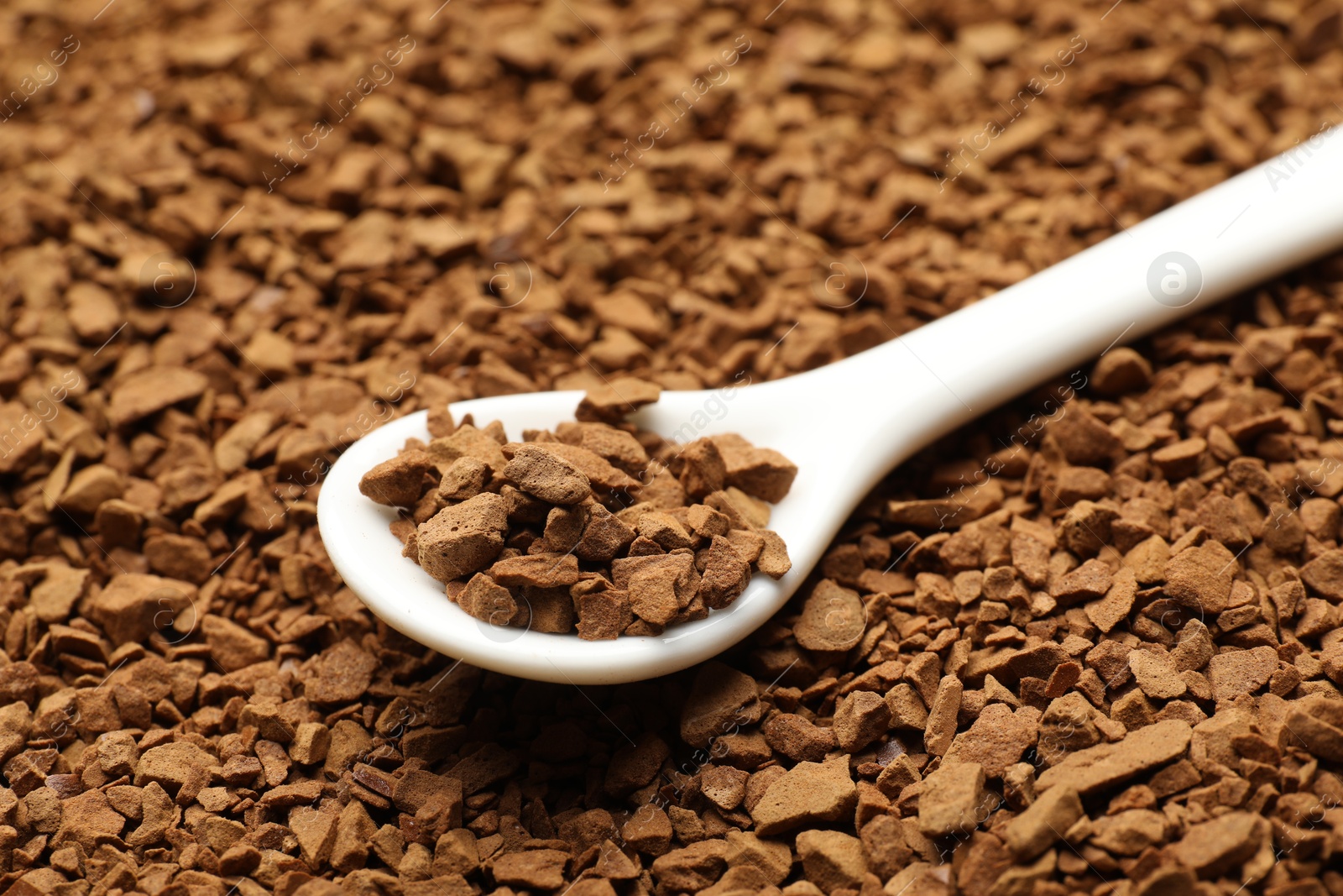 Spoon with aromatic instant coffee as background, closeup Photo of Spoon with aromatic instant coffee as background, closeup