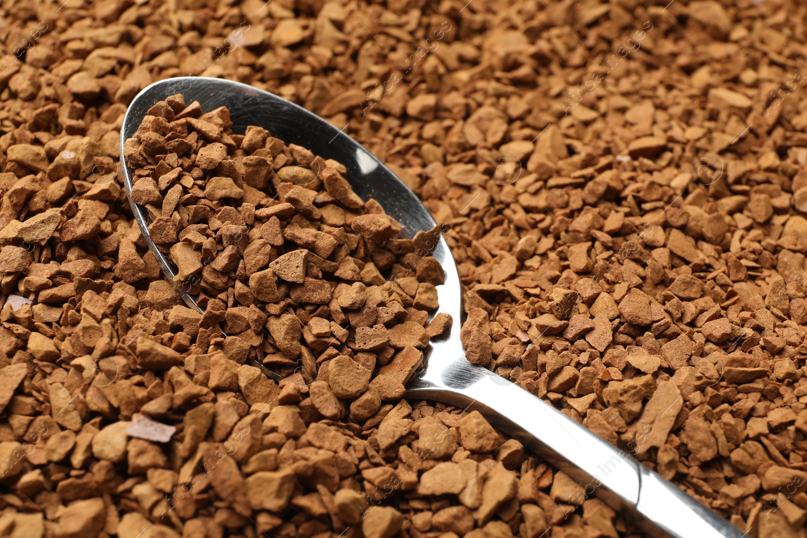 Spoon with aromatic instant coffee as background, closeup Photo of Spoon with aromatic instant coffee as background, closeup