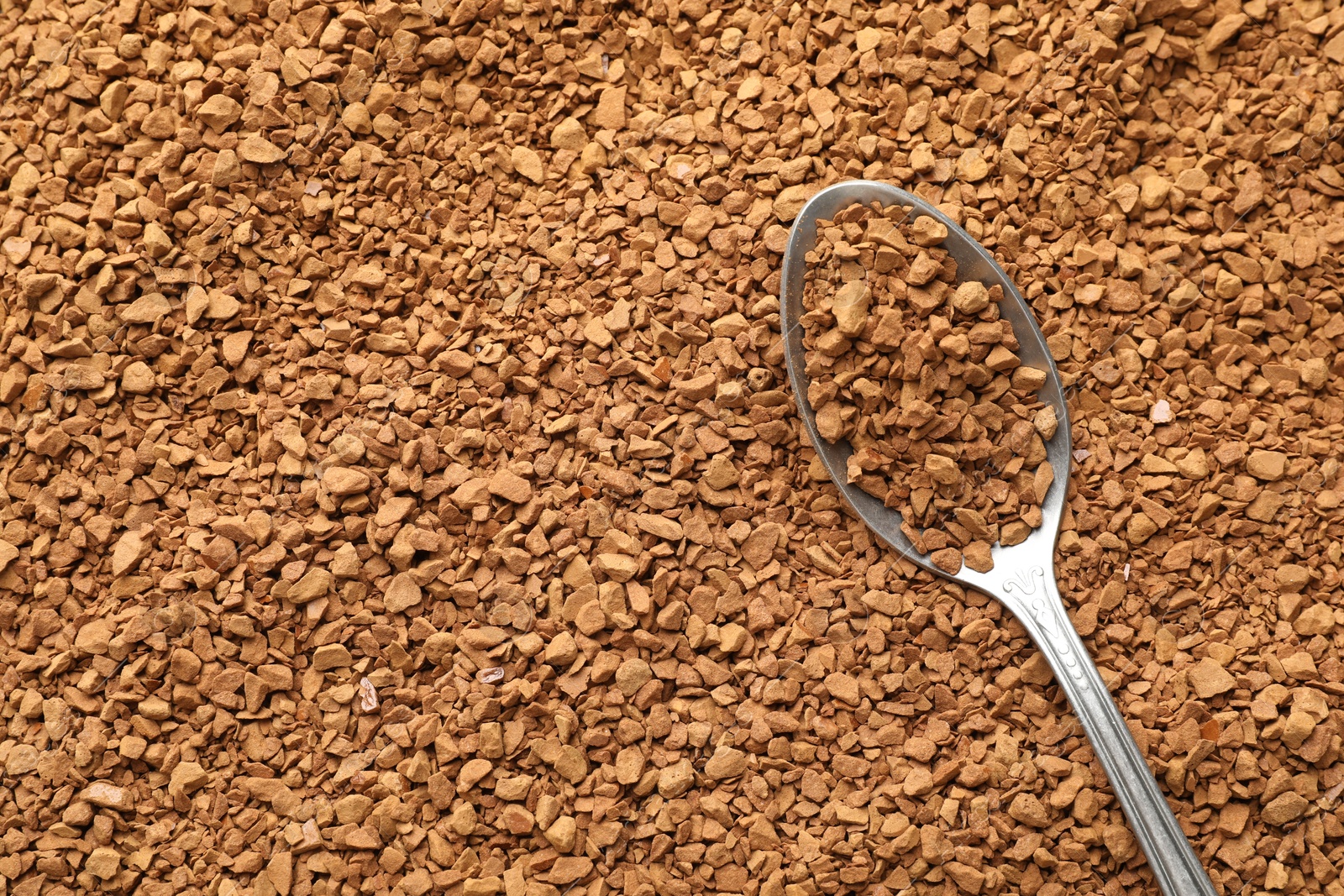 Spoon with aromatic instant coffee as background, closeup Photo of Spoon with aromatic instant coffee as background, closeup