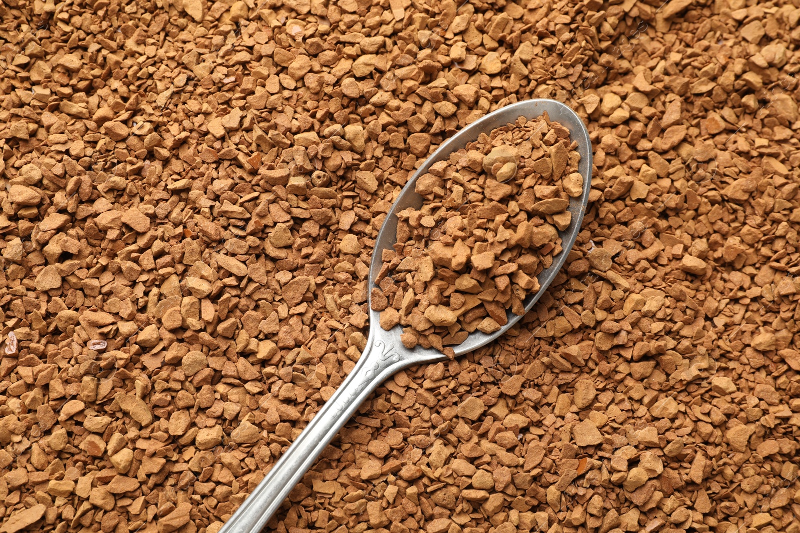 Spoon with aromatic instant coffee as background, closeup Photo of Spoon with aromatic instant coffee as background, closeup