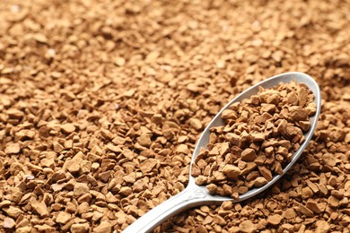 Photo of Spoon with aromatic instant coffee as background, closeup