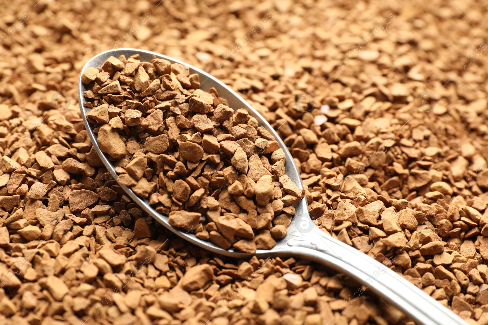 Spoon with aromatic instant coffee as background, closeup Photo of Spoon with aromatic instant coffee as background, closeup