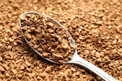 Photo of Spoon with aromatic instant coffee as background, closeup