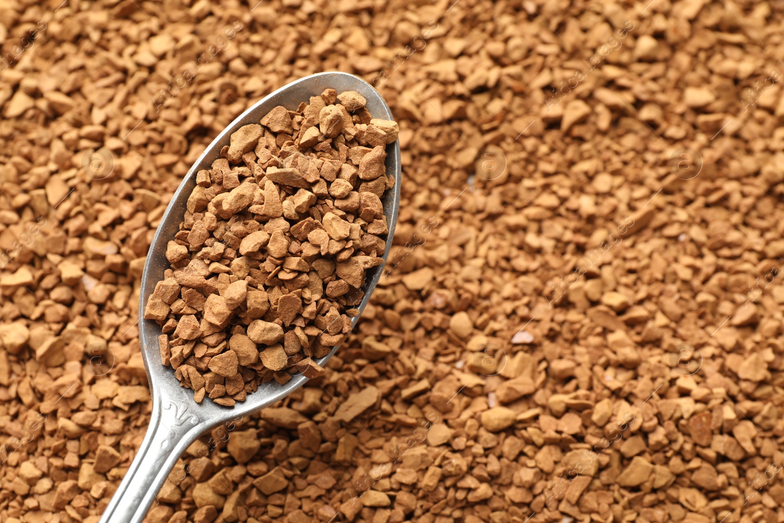 Spoon with aromatic instant coffee as background, closeup Photo of Spoon with aromatic instant coffee as background, closeup