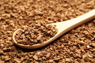 Photo of Spoon with aromatic instant coffee as background, closeup