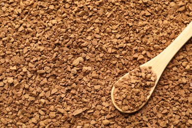 Photo of Spoon with aromatic instant coffee as background, closeup