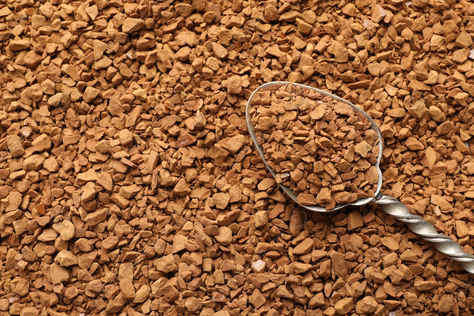Spoon with aromatic instant coffee as background, closeup Photo of Spoon with aromatic instant coffee as background, closeup