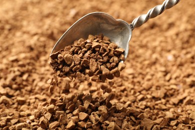 Photo of Spoon with aromatic instant coffee as background, closeup