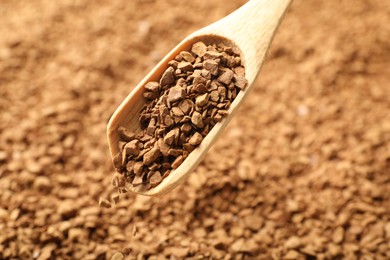 Photo of Spoon with aromatic instant coffee as background, closeup