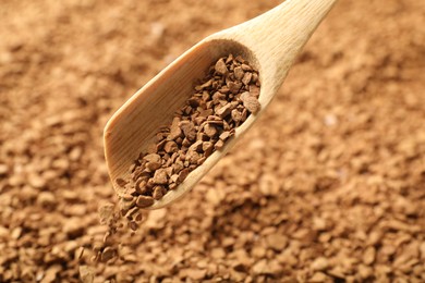 Photo of Spoon with aromatic instant coffee as background, closeup