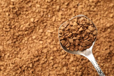 Photo of Spoon with aromatic instant coffee as background, closeup