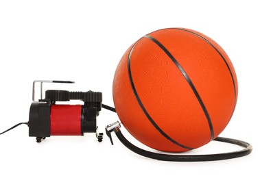 Photo of Basketball ball and air compressor isolated on white