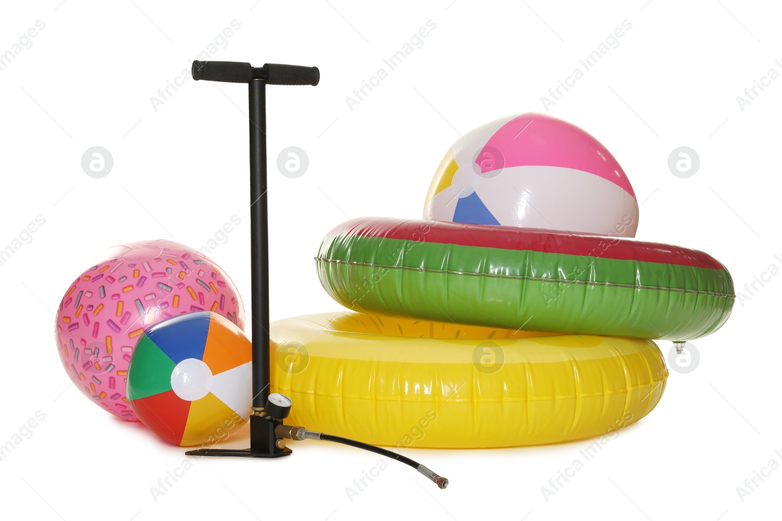 Inflatable rings, balls and manual air pump isolated on white Photo of Inflatable rings, balls and manual air pump isolated on white