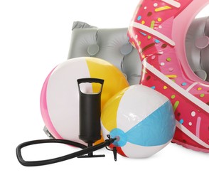 Photo of Inflatable ring, mattress, balls and manual air pump isolated on white