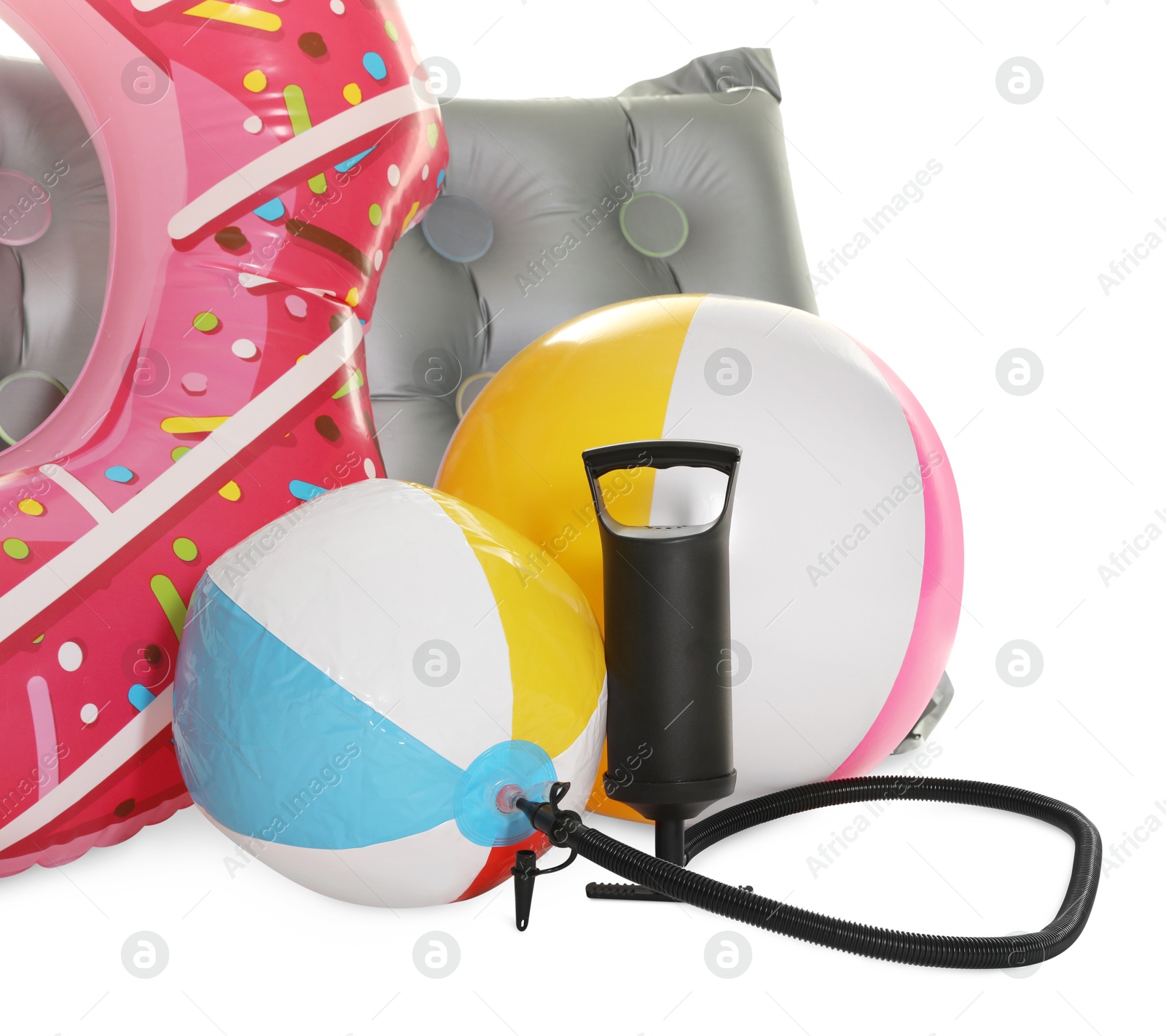 Inflatable ring, mattress, balls and manual air pump isolated on white Photo of Inflatable ring, mattress, balls and manual air pump isolated on white