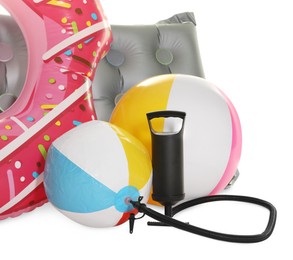 Photo of Inflatable ring, mattress, balls and manual air pump isolated on white
