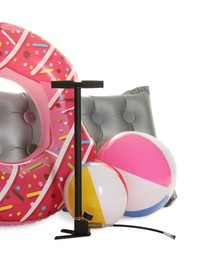 Photo of Inflatable ring, mattress, balls and manual air pump isolated on white