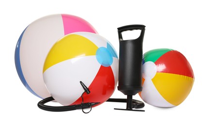 Photo of Inflatable balls and manual air pump isolated on white